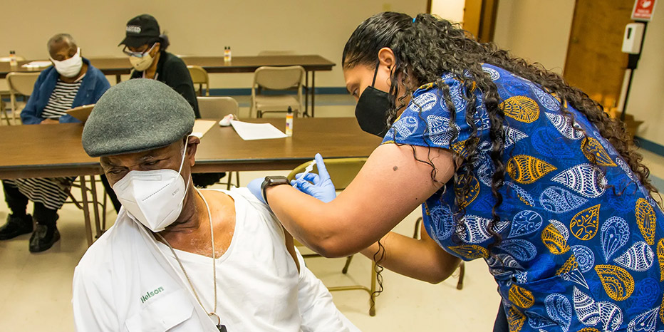 A healthcare worker administers a vaccine to a patient.
